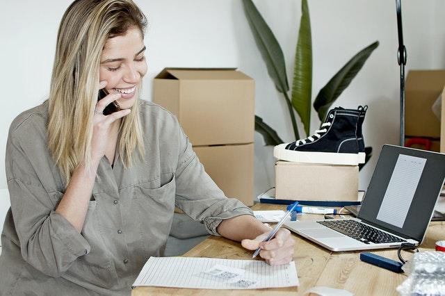 woman working at desk on phone